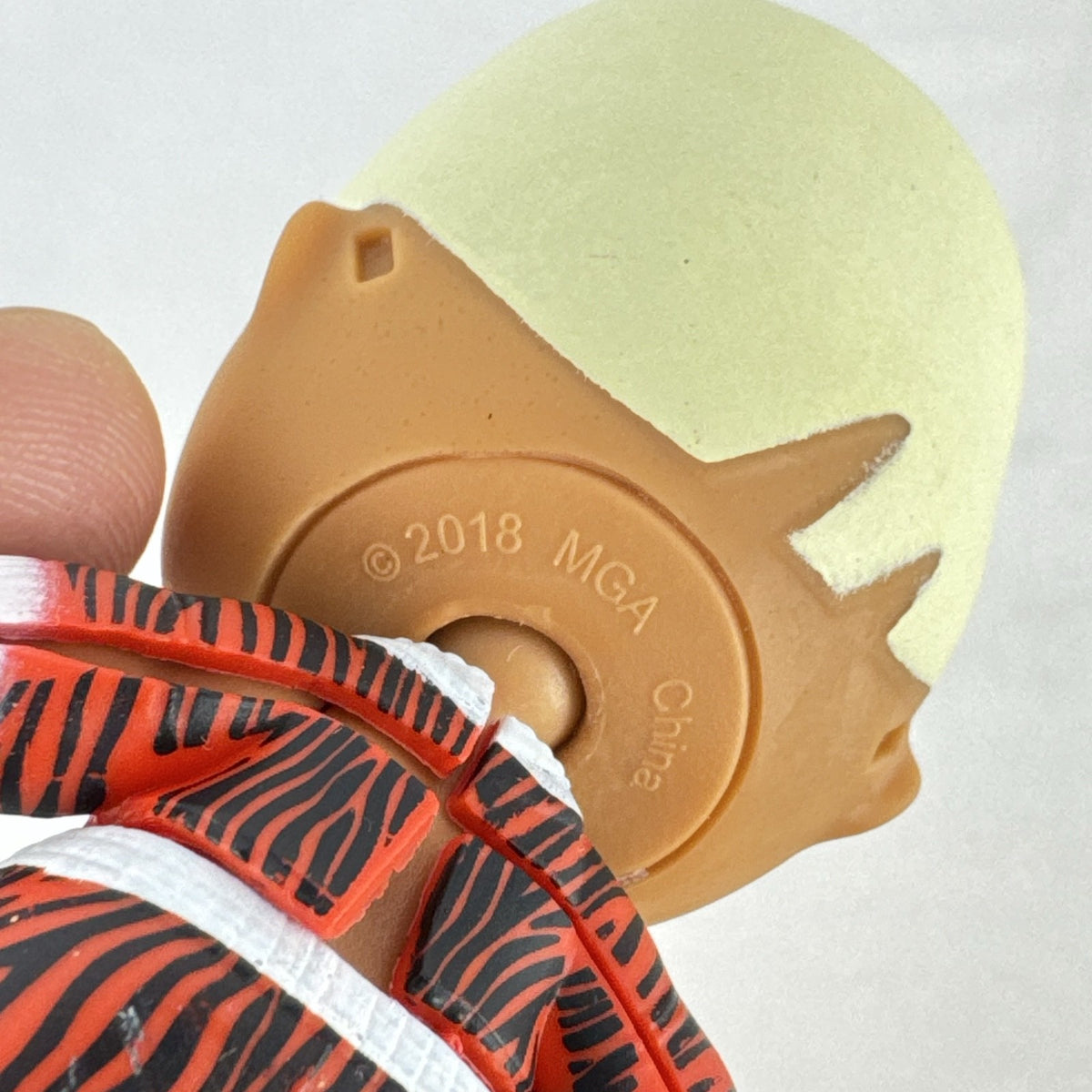 MGA L.O.L. Surprise Boys Swaggy 3-inch mini doll with blonde flocked hair and red tracksuit.