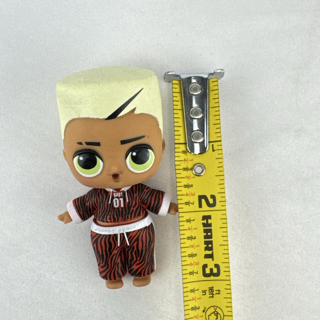 MGA L.O.L. Surprise Boys Swaggy 3-inch mini doll with blonde flocked hair and red tracksuit.