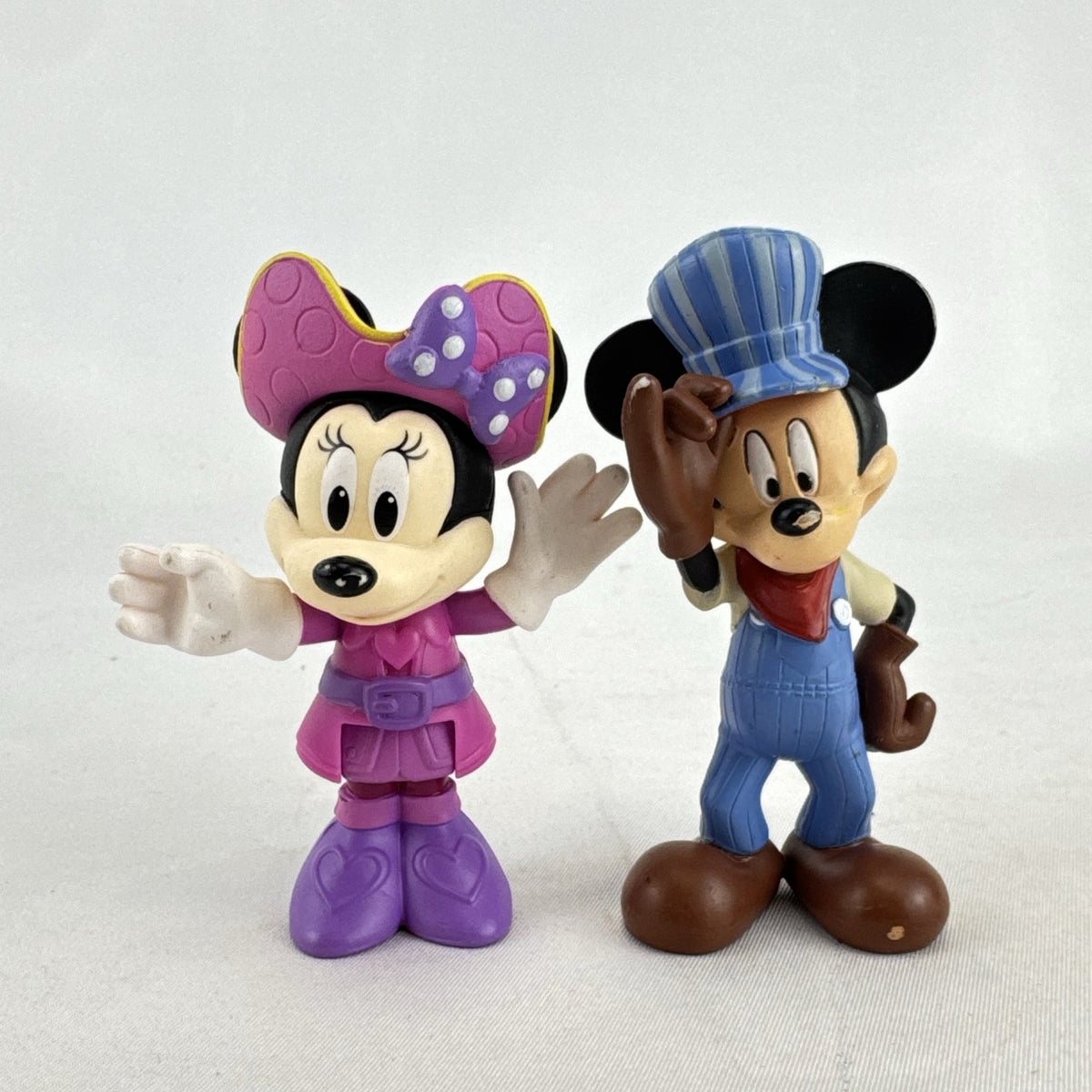 Disney 3-inch molded plastic Mickey Mouse train conductor and Minnie Mouse pirate action figures