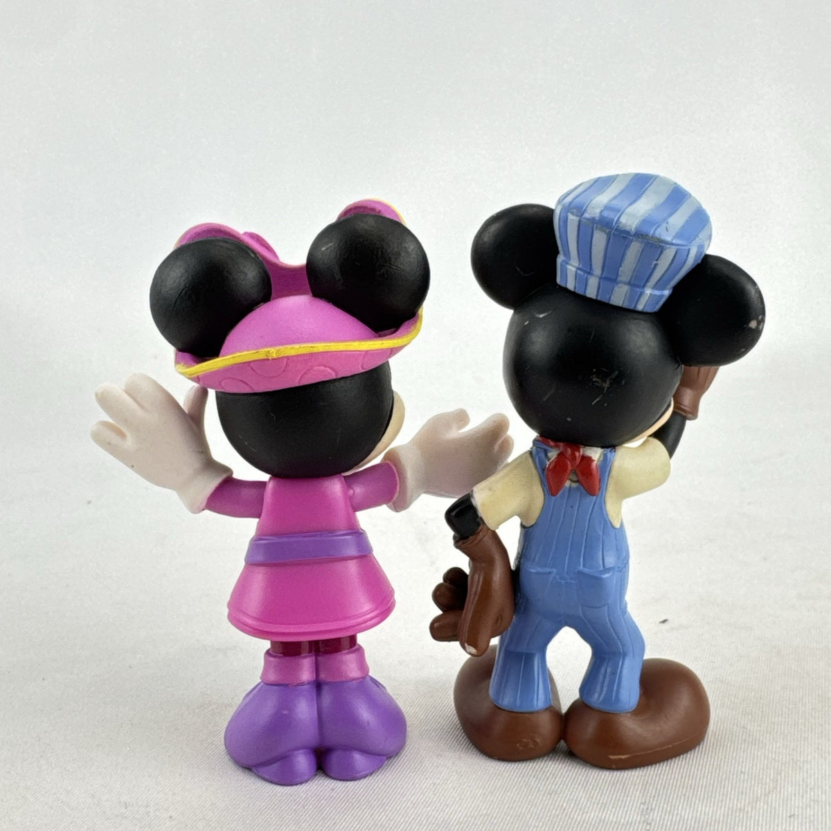 Disney 3-inch molded plastic Mickey Mouse train conductor and Minnie Mouse pirate action figures