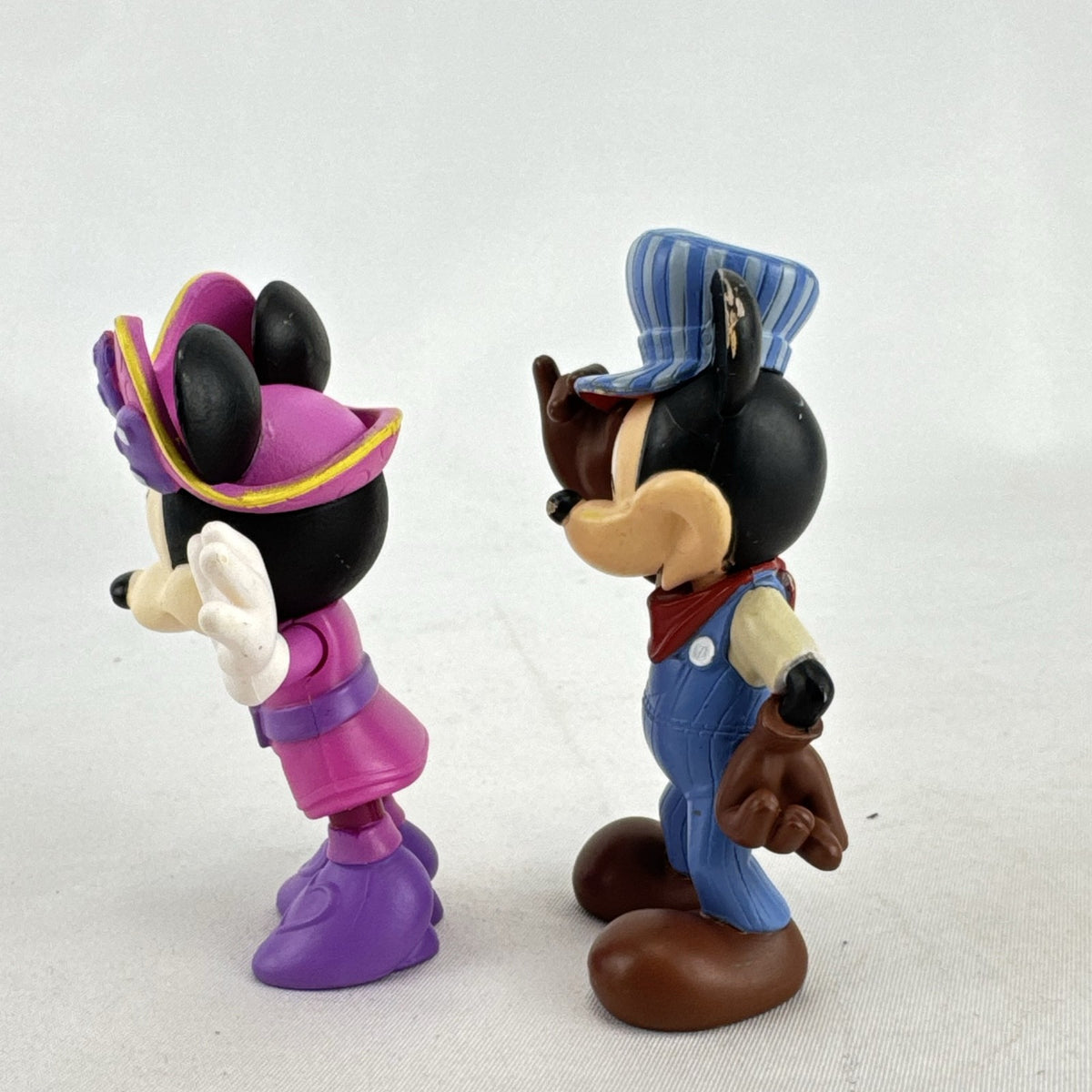 Disney 3-inch molded plastic Mickey Mouse train conductor and Minnie Mouse pirate action figures
