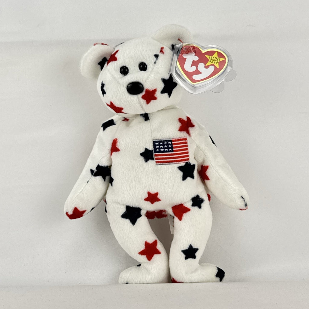 Ty Beanie Baby Glory bear plush featuring patriotic red and navy blue stars and an embroidered American flag