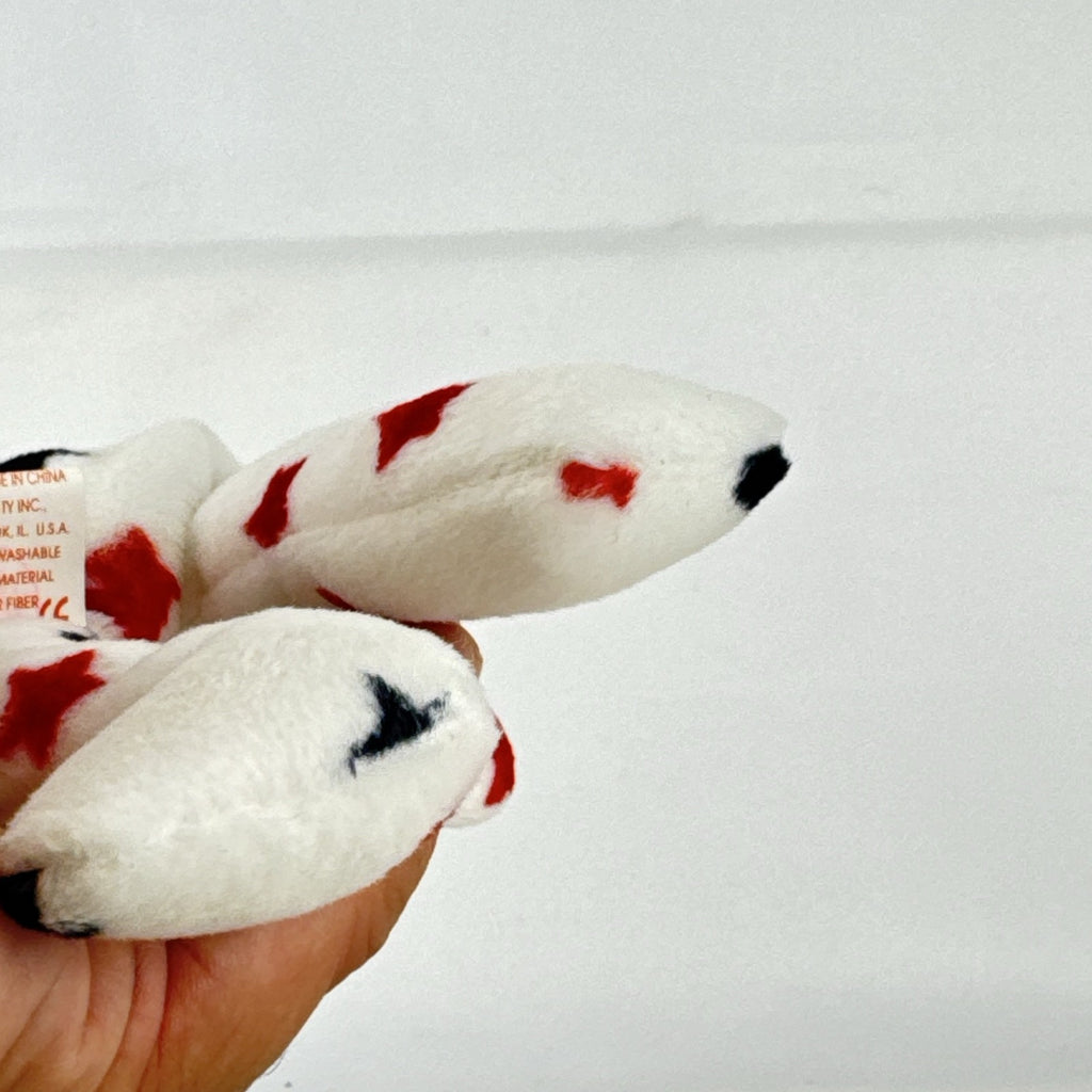 Ty Beanie Baby Glory bear plush featuring patriotic red and navy blue stars and an embroidered American flag