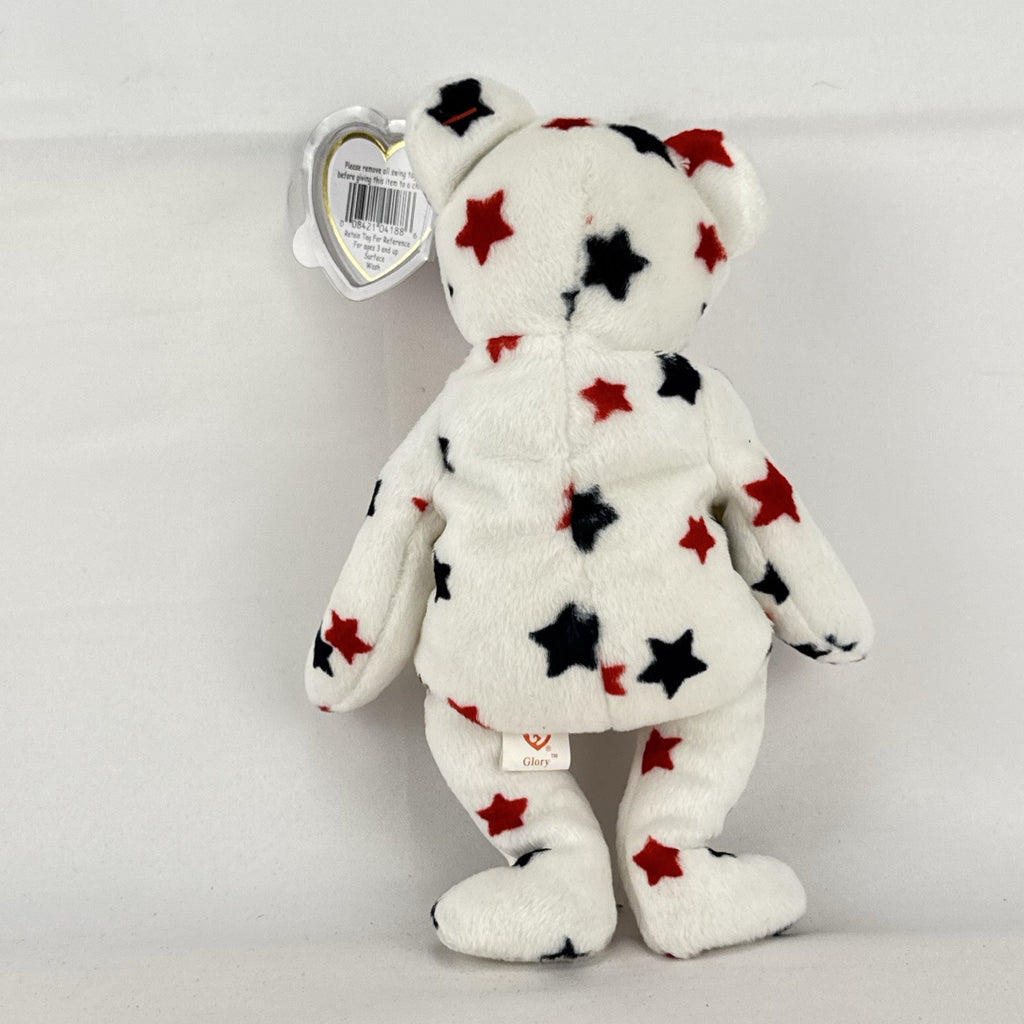 Ty Beanie Baby Glory bear plush featuring patriotic red and navy blue stars and an embroidered American flag