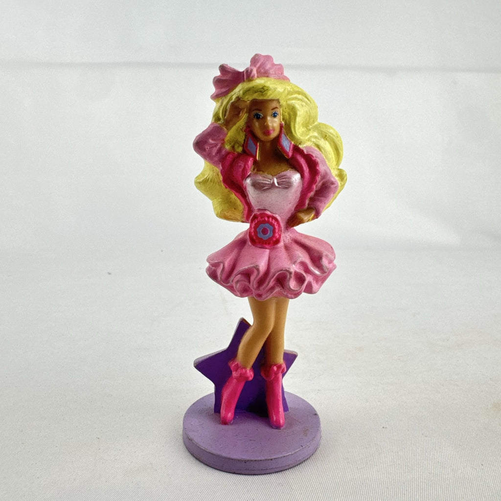 Vintage 1991 Mattel Barbie McDonald's Happy Meal plastic figurine wearing pink dress against a purple star