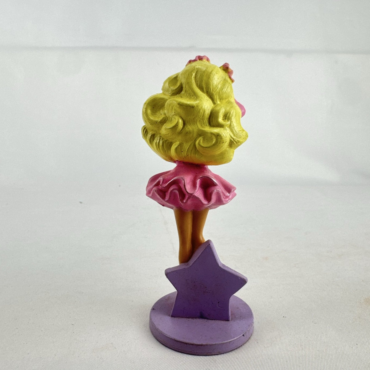 Vintage 1991 Mattel Barbie McDonald's Happy Meal plastic figurine wearing pink dress against a purple star