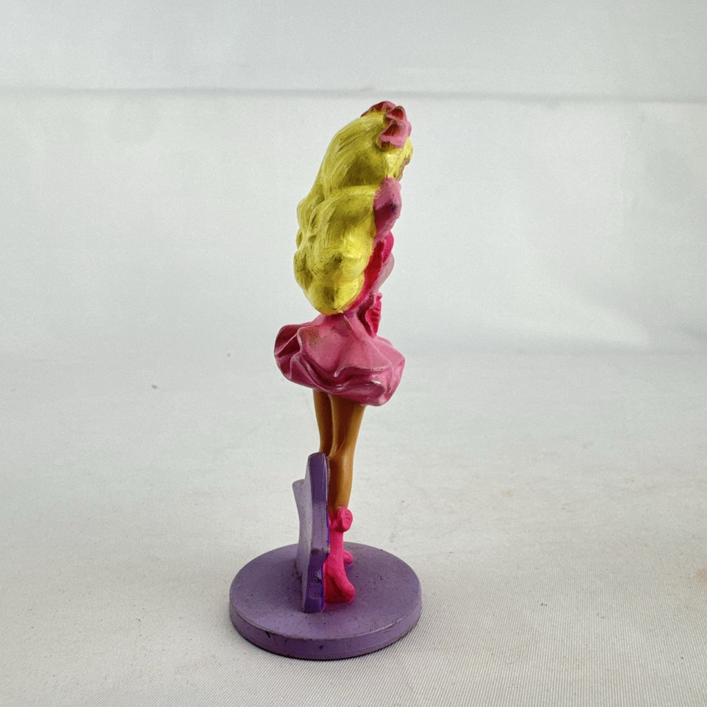 Vintage 1991 Mattel Barbie McDonald's Happy Meal plastic figurine wearing pink dress against a purple star