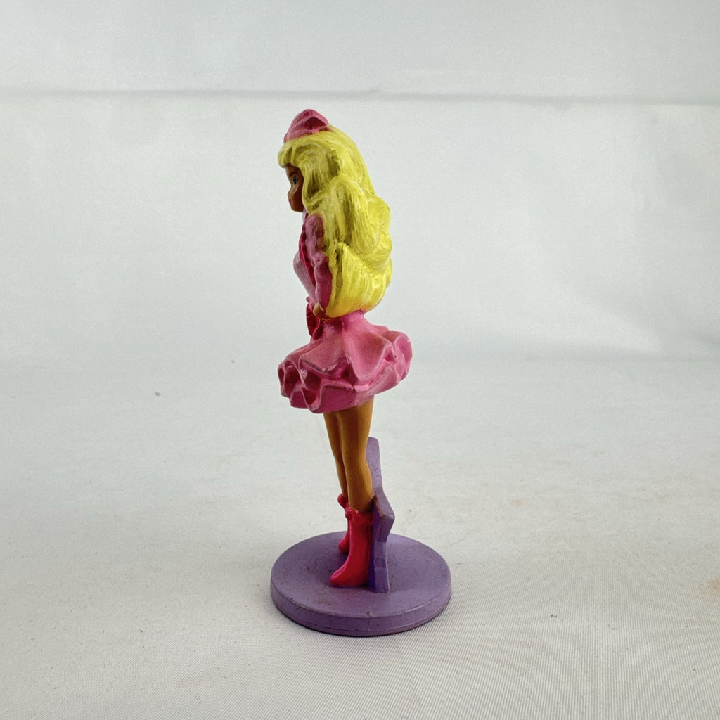 Vintage 1991 Mattel Barbie McDonald's Happy Meal plastic figurine wearing pink dress against a purple star
