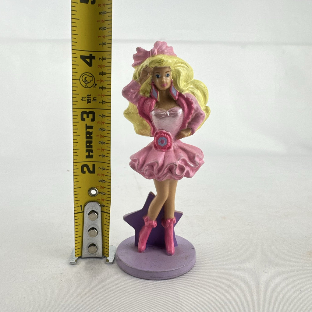 Vintage 1991 Mattel Barbie McDonald's Happy Meal plastic figurine wearing pink dress against a purple star