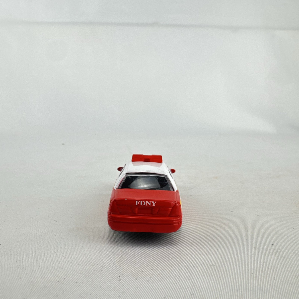Realtoy 1:64 scale diecast Ford Crown Victoria FDNY emergency vehicle in red and white