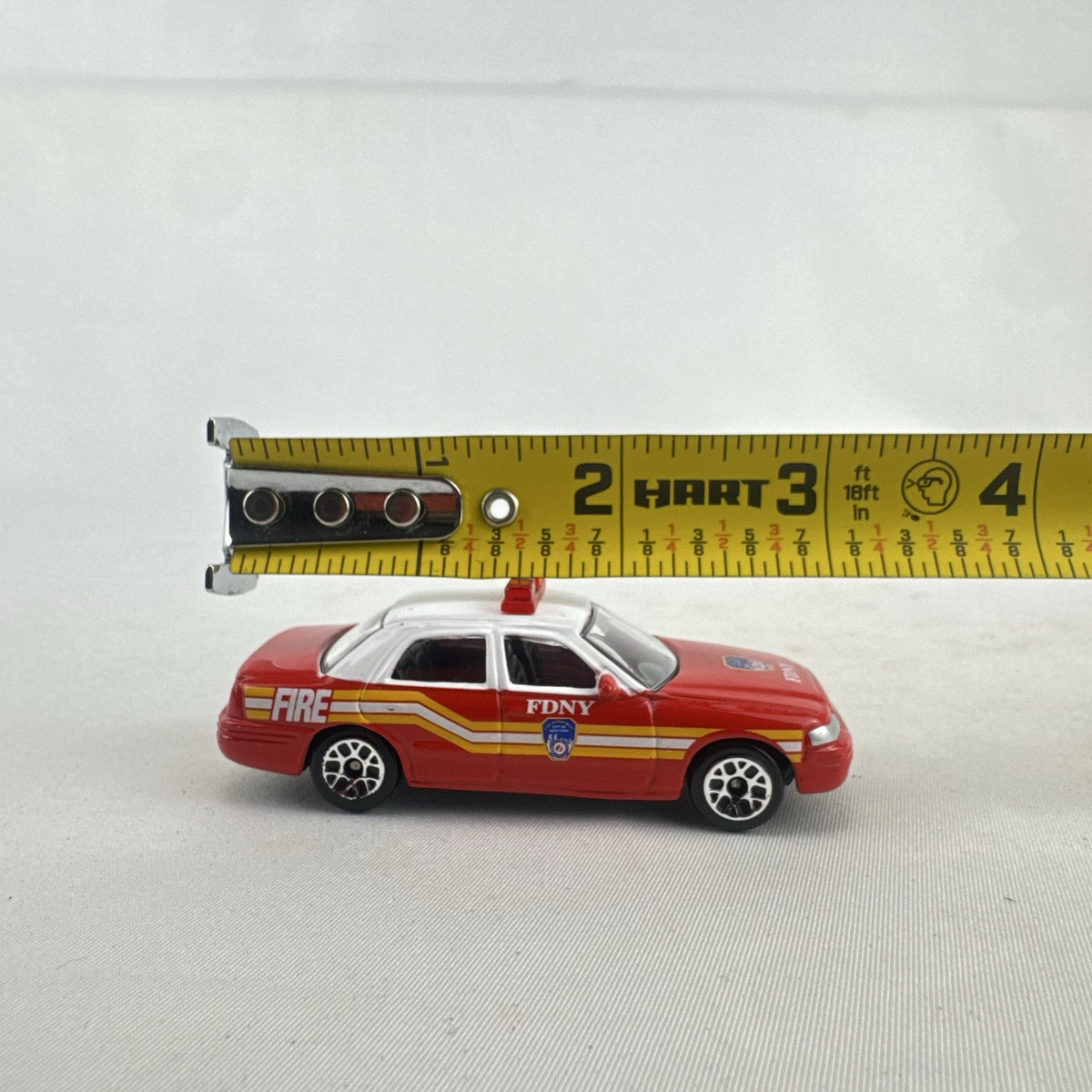 Realtoy 1:64 scale diecast Ford Crown Victoria FDNY emergency vehicle in red and white
