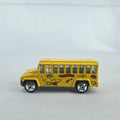 Matchbox 1:64 scale yellow diecast school bus with History dinosaur and rocket graphics