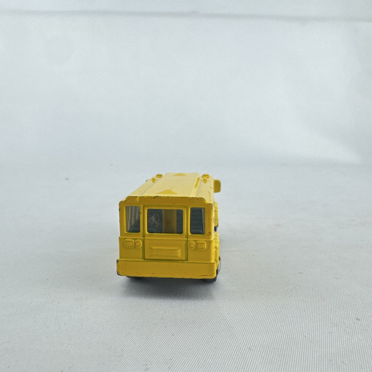 Matchbox 1:64 scale yellow diecast school bus with History dinosaur and rocket graphics