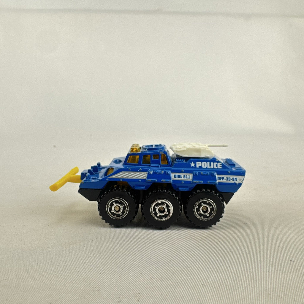 Vintage 1993 Matchbox Battering Ram blue diecast 6x6 police armored truck with rotating turret and front plow.