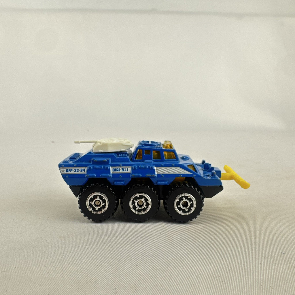 Vintage 1993 Matchbox Battering Ram blue diecast 6x6 police armored truck with rotating turret and front plow.