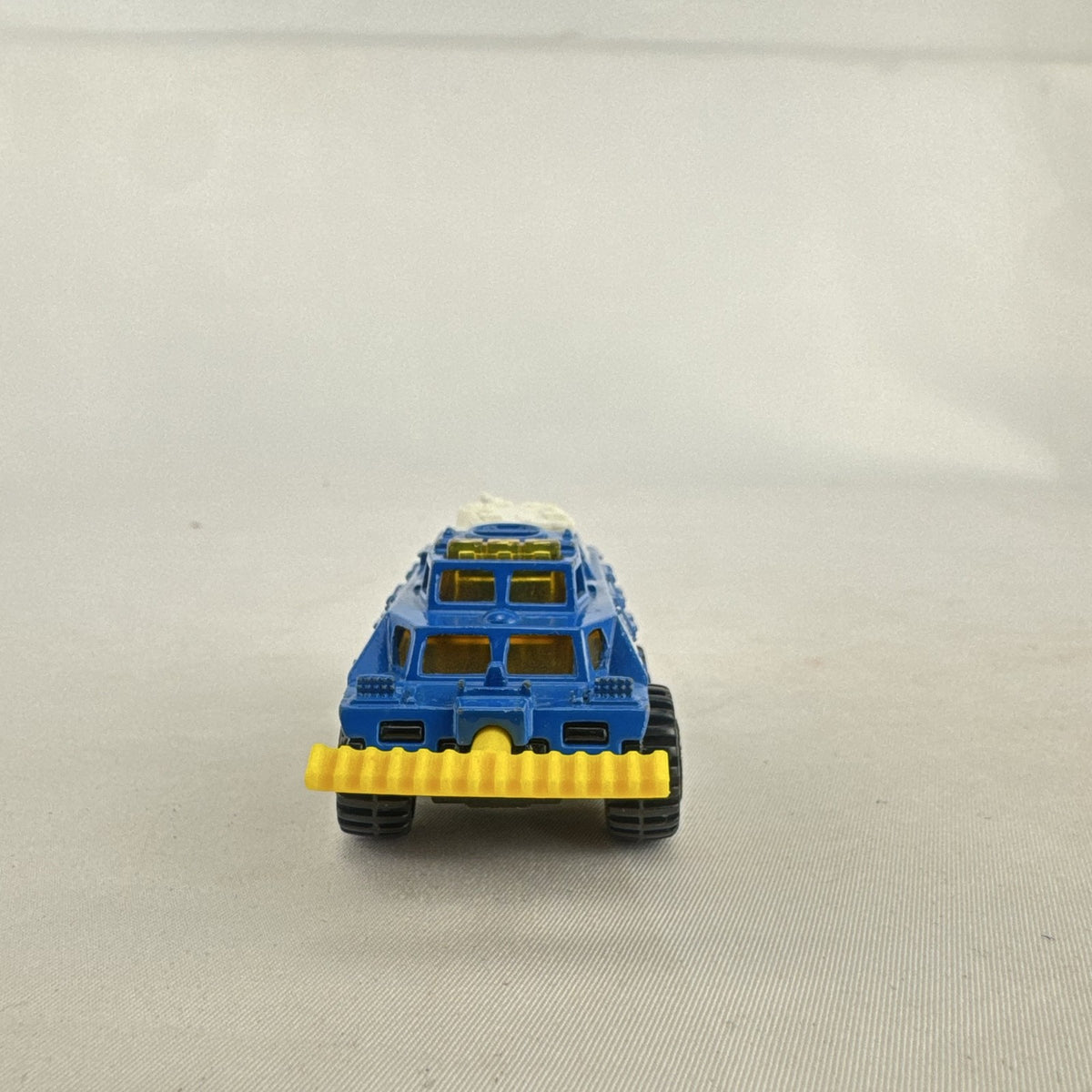 Vintage 1993 Matchbox Battering Ram blue diecast 6x6 police armored truck with rotating turret and front plow.