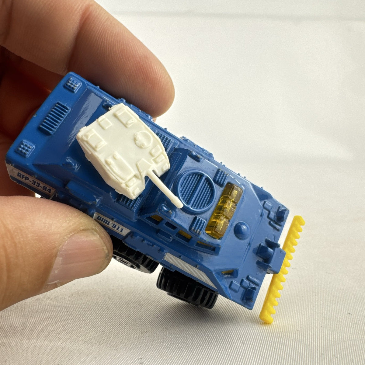 Vintage 1993 Matchbox Battering Ram blue diecast 6x6 police armored truck with rotating turret and front plow.