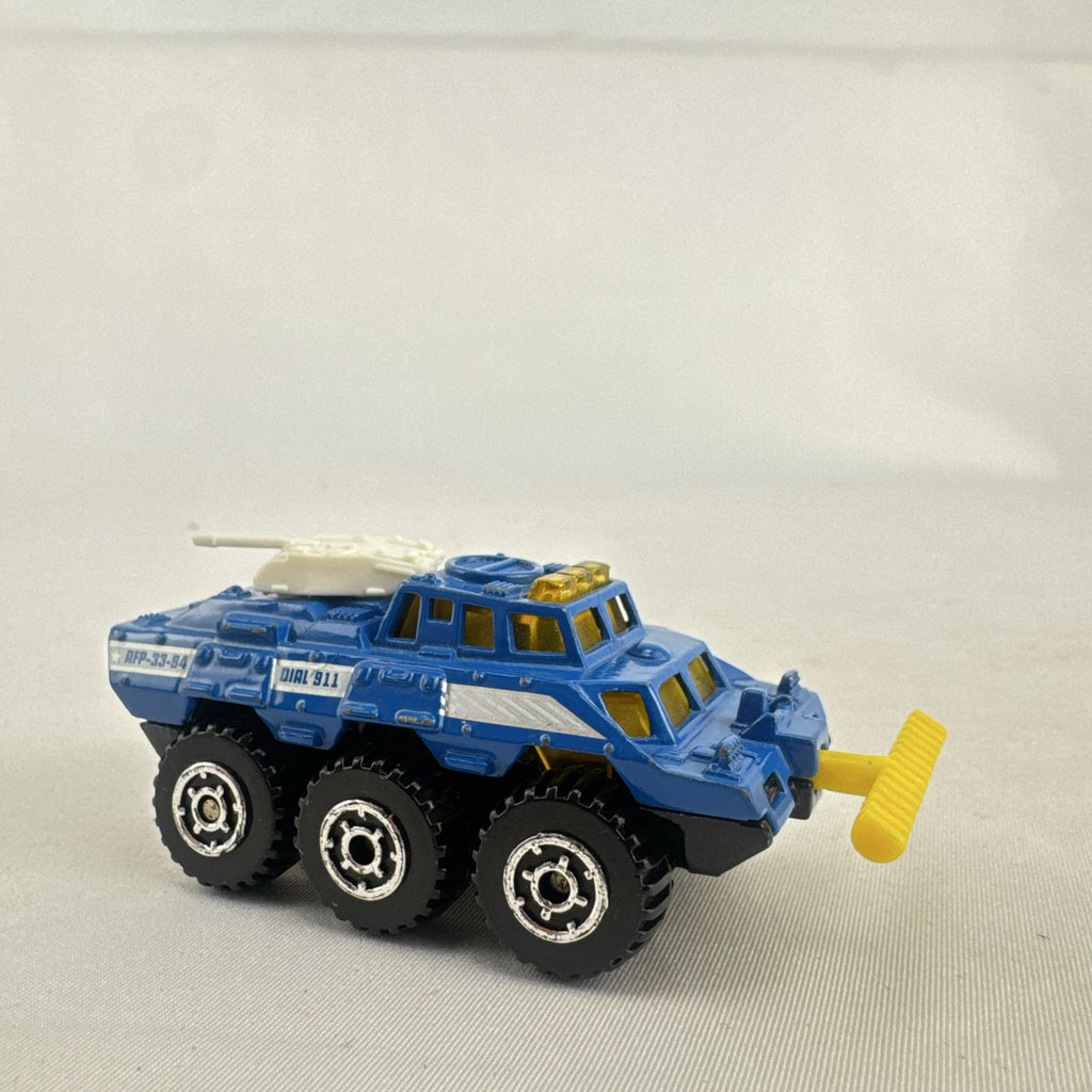 Vintage 1993 Matchbox Battering Ram blue diecast 6x6 police armored truck with rotating turret and front plow.