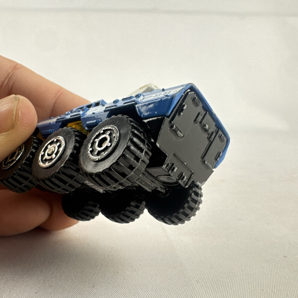 Vintage 1993 Matchbox Battering Ram blue diecast 6x6 police armored truck with rotating turret and front plow.