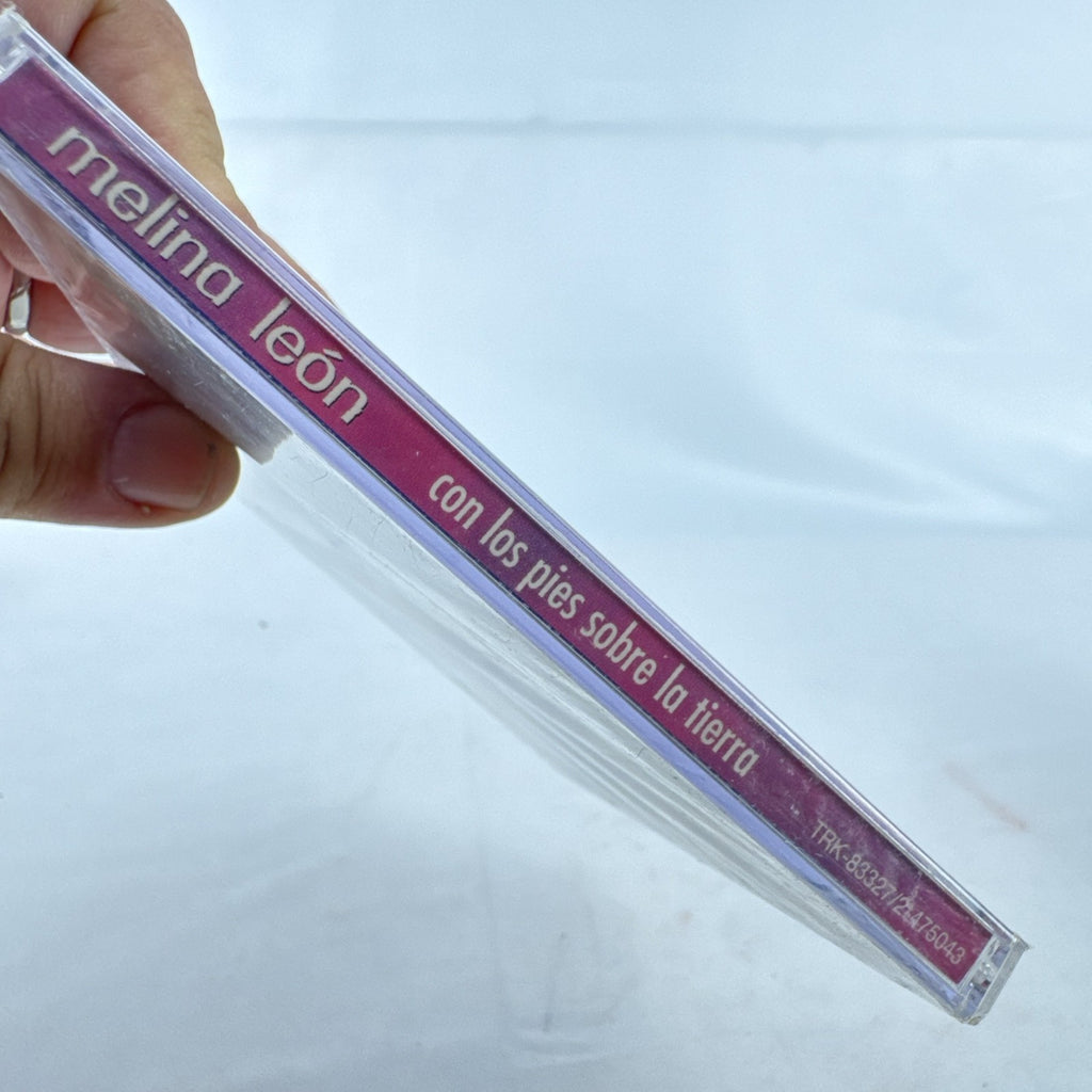 Factory-sealed 1999 CD album cover of Melina León's Con Los Pies Sobre La Tierra on Sony Discos