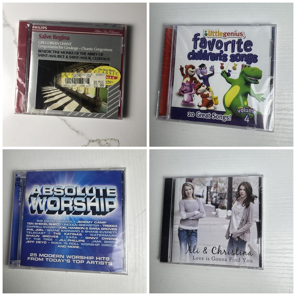 Set of 4 factory-sealed CDs including Salve Regina Gregorian Chant, Absolute Worship, and Little Genius children's songs.