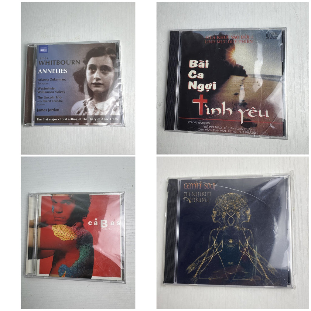 Set of four factory-sealed music CDs featuring classical, Latin pop, neo-soul, and sacred vocal albums.