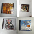 Lot of 4 factory sealed Christmas music CDs including Latin, acoustic, and classical holiday albums.