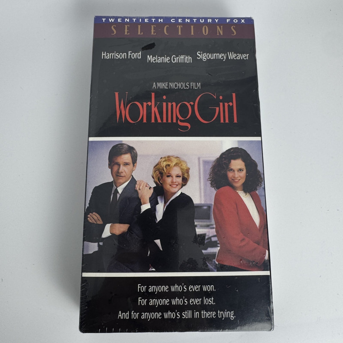 Lot of 3 factory-sealed VHS tapes including Working Girl, Snowden's Christmas, and Rudolph Frosty Sing Along