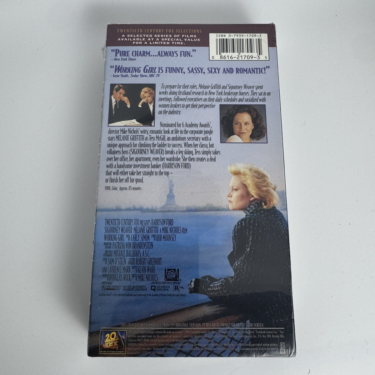 Lot of 3 factory-sealed VHS tapes including Working Girl, Snowden's Christmas, and Rudolph Frosty Sing Along