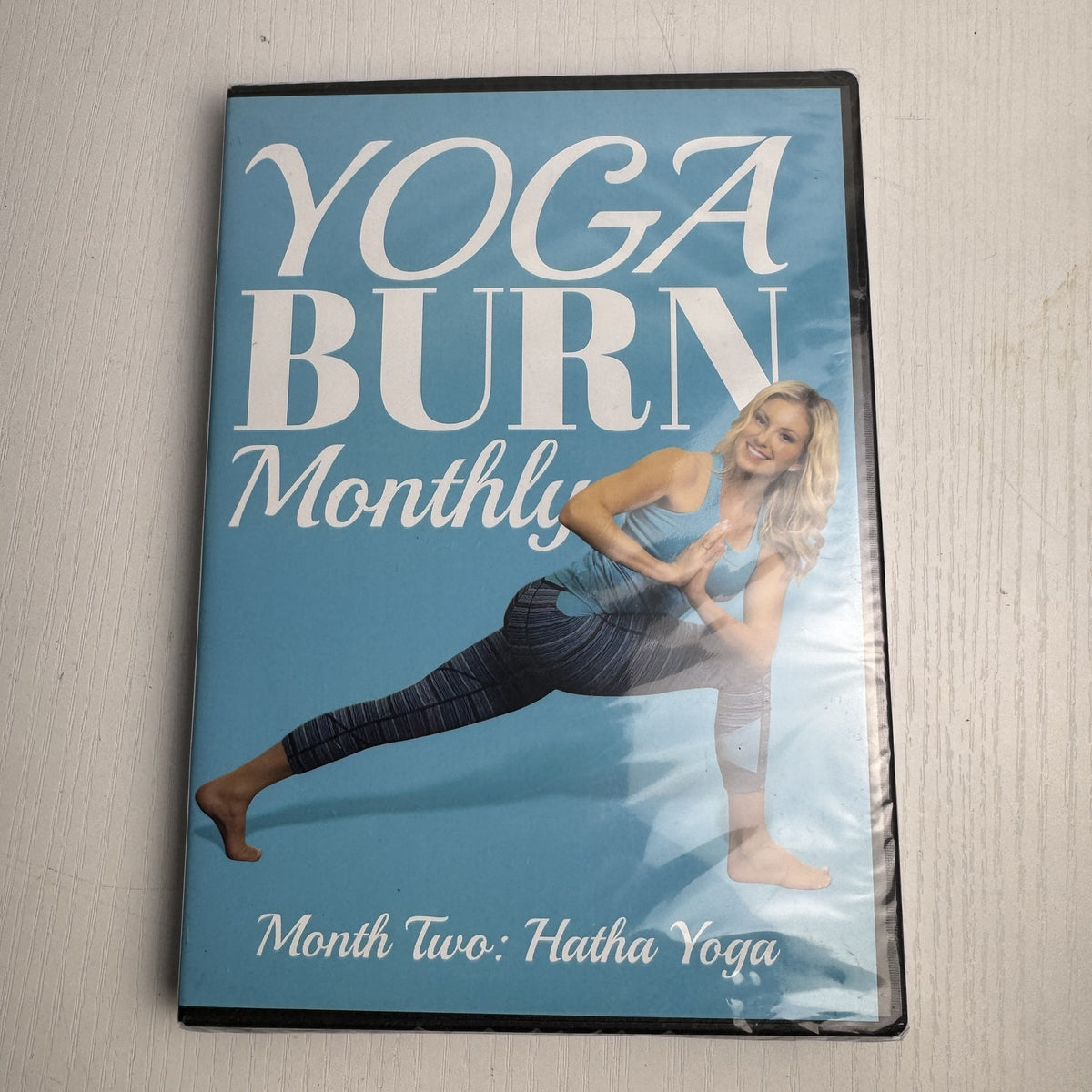 Set of four factory-sealed Yoga Burn Monthly and NOOMA Breathe home fitness DVDs
