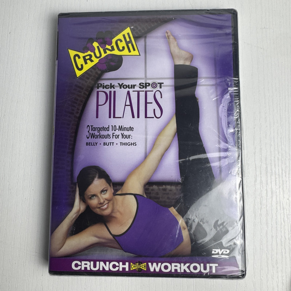 Factory-sealed retro fitness and wellness media lot featuring four DVD and VHS titles including Crunch and The Firm.