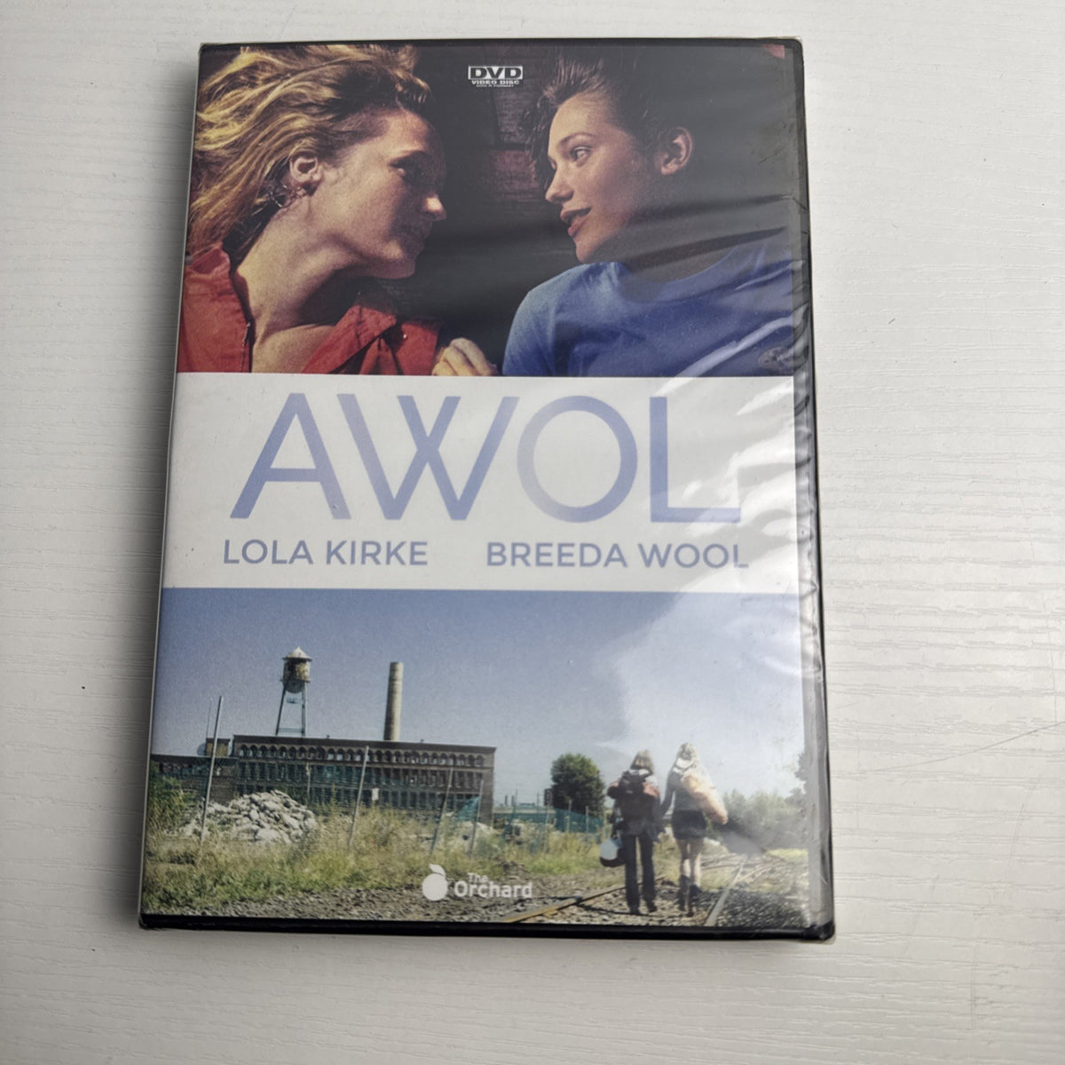 Four factory-sealed DVD movie cases including A Tale of Two Guns, American Teacher, AWOL, and A Piece of Eden.