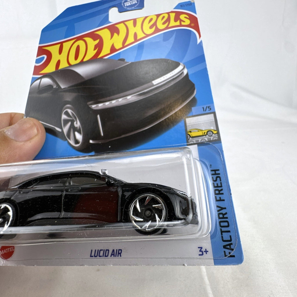 Hot Wheels Factory Fresh 1:64 6-car diecast lot including Nissan Z Proto, Volvo 850 Estate, Land Rover, and Lucid Air.