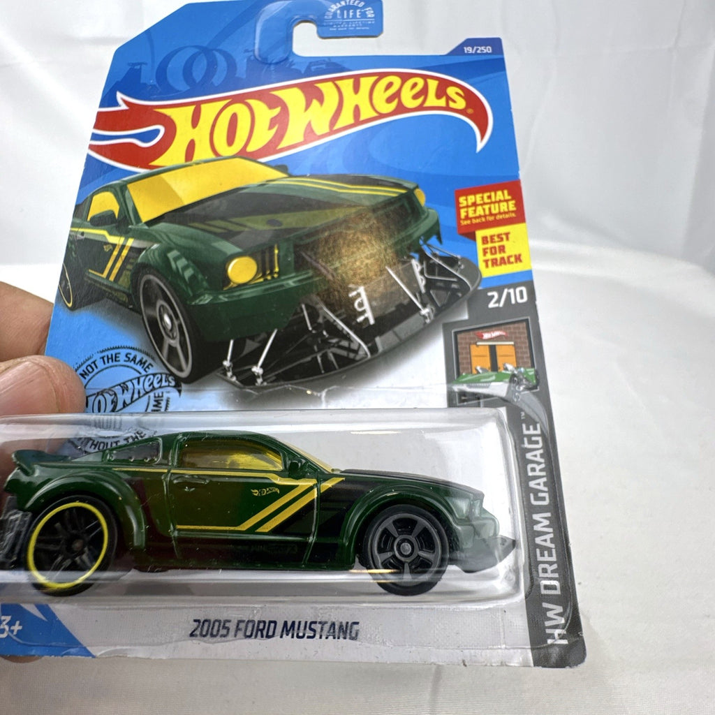 Hot Wheels HW Dream Garage 9-car diecast muscle car lot featuring Chevrolet and Ford models sealed on card.