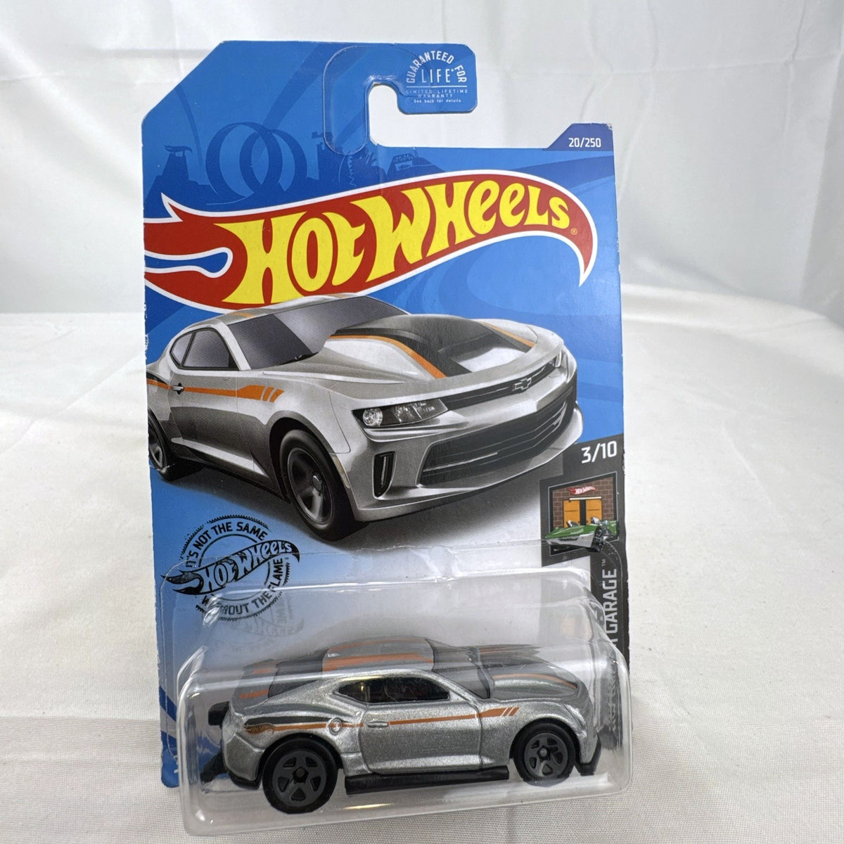 Hot Wheels HW Dream Garage 9-car diecast muscle car lot featuring Chevrolet and Ford models sealed on card.