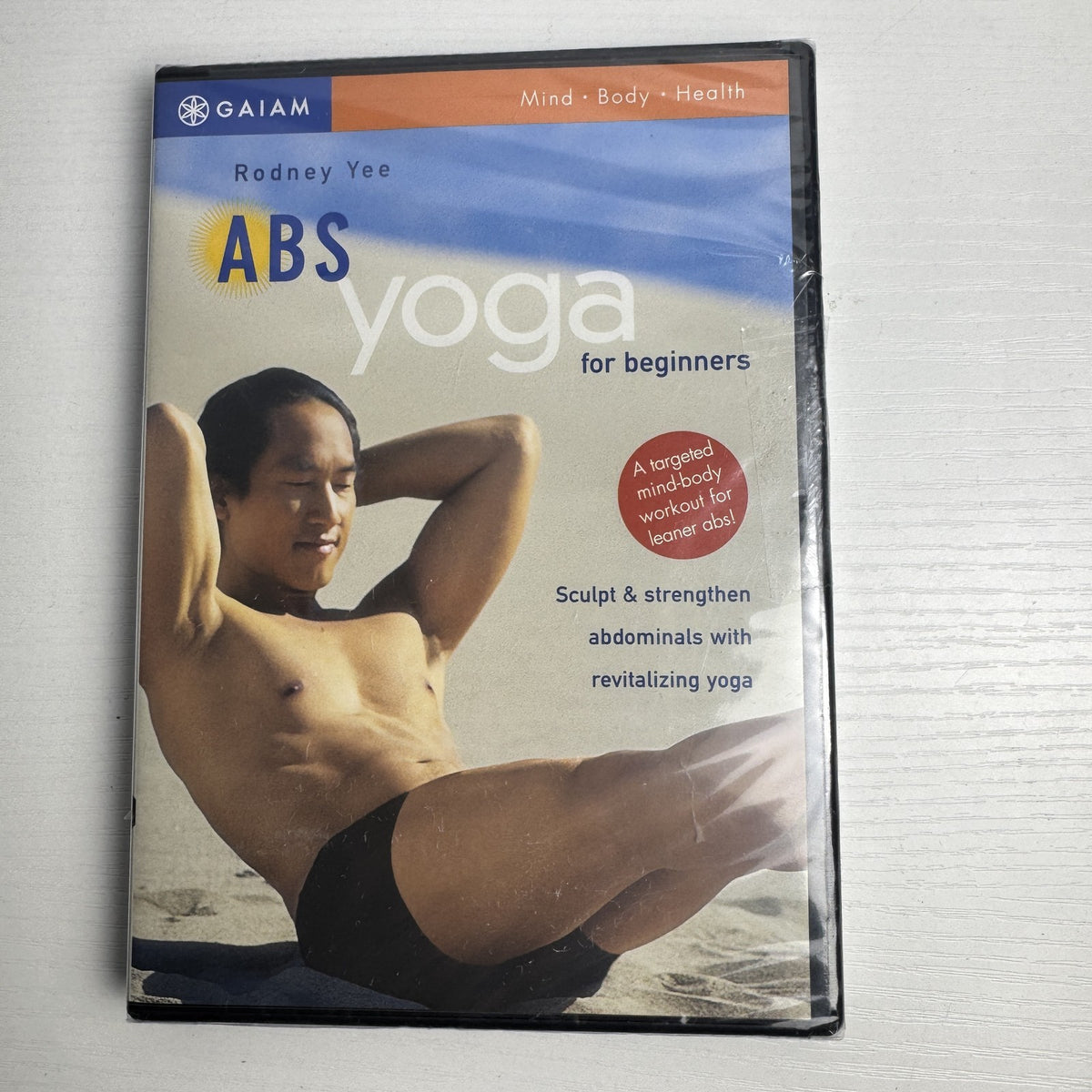 Front cover of Gaiam's Abs Yoga for Beginners DVD with Rodney Yee, brand new in original factory shrink wrap.