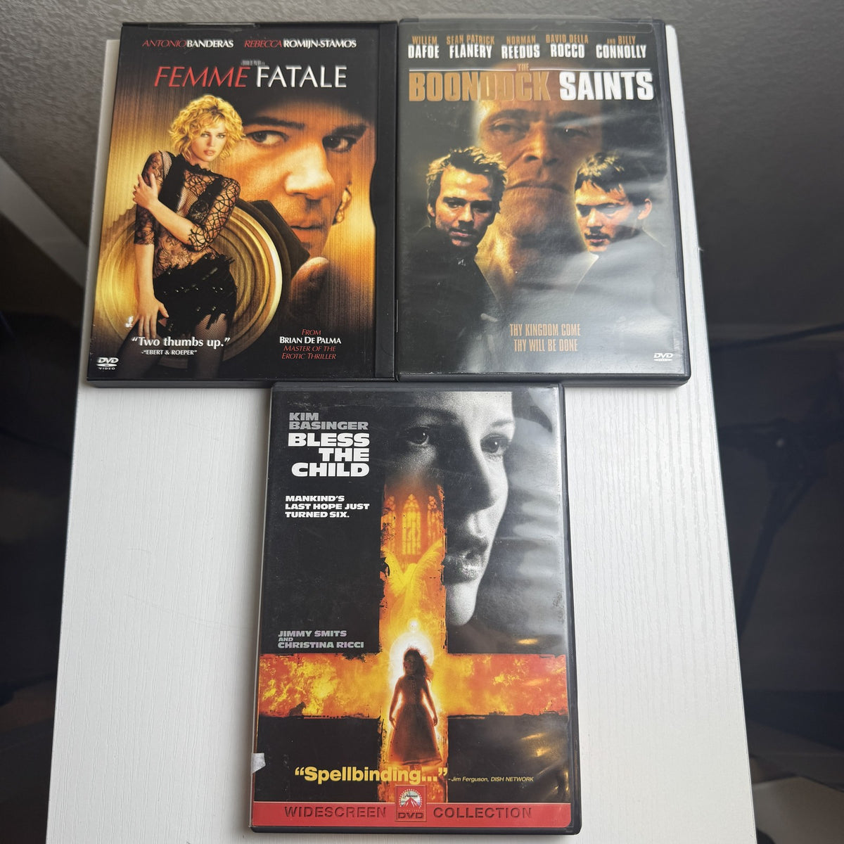 Three-film thriller DVD bundle featuring titles The Boondock Saints, Femme Fatale, and Bless The Child
