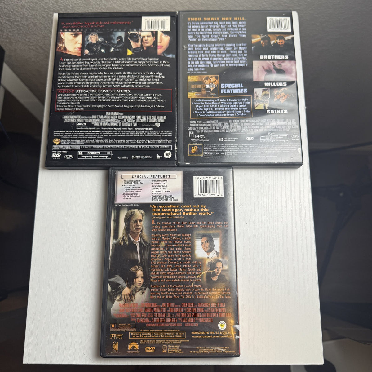 Three-film thriller DVD bundle featuring titles The Boondock Saints, Femme Fatale, and Bless The Child