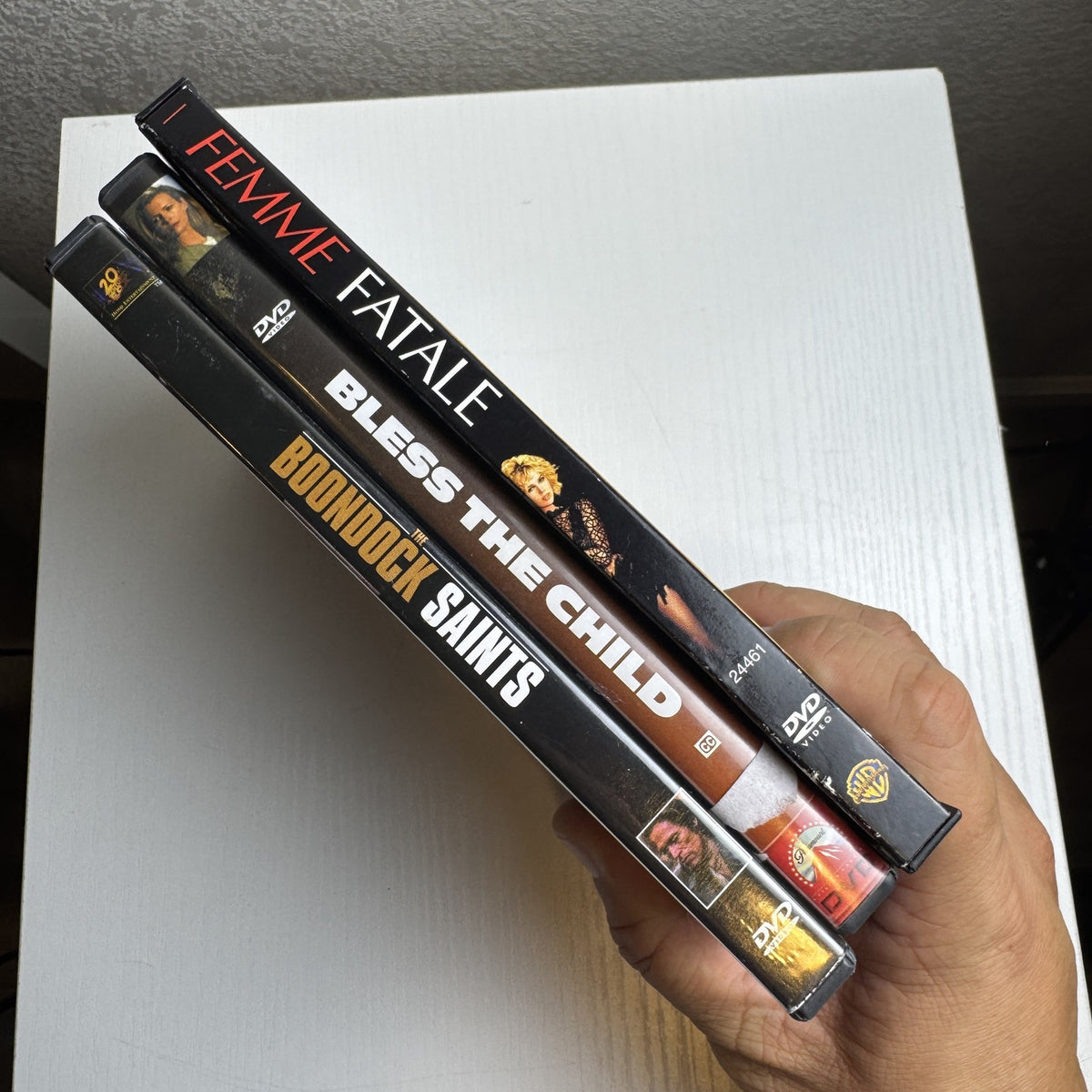 Three-film thriller DVD bundle featuring titles The Boondock Saints, Femme Fatale, and Bless The Child