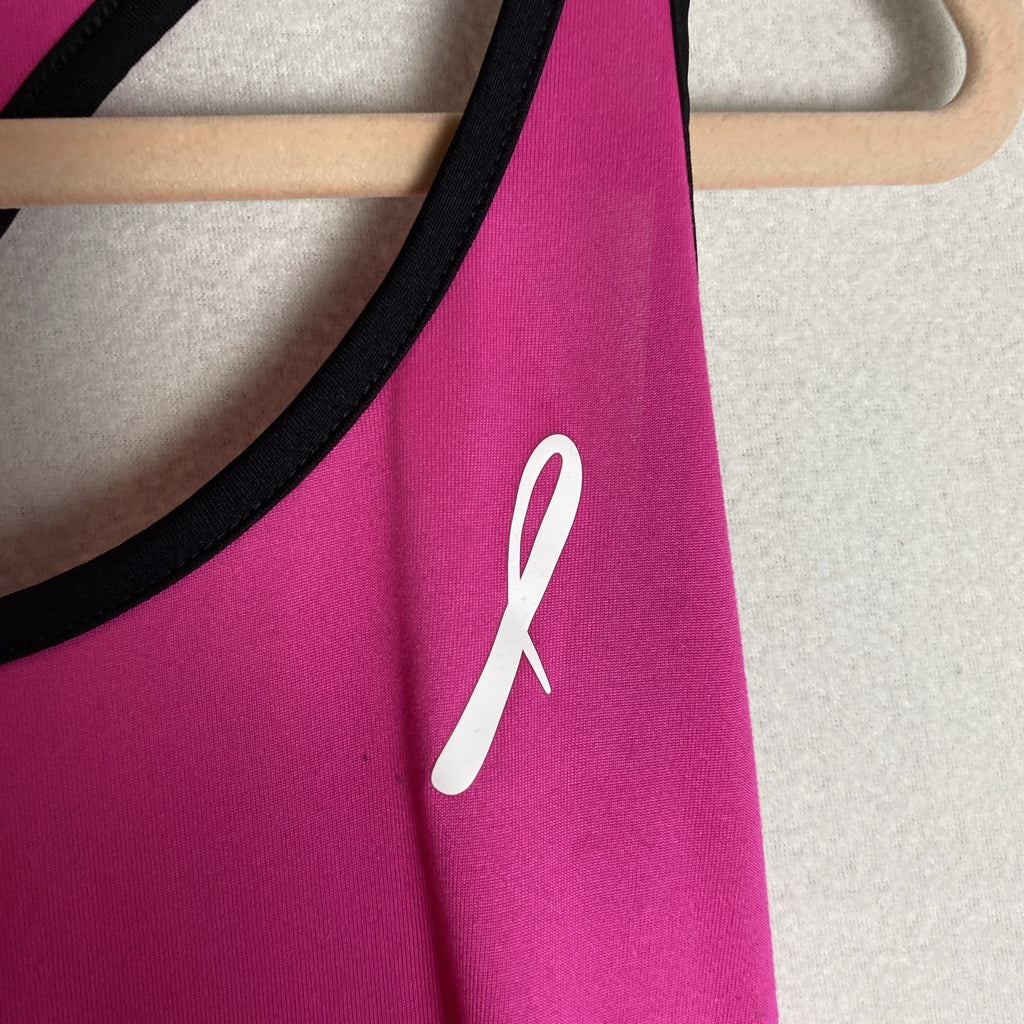 Reebok women's pink and black PlayDry racerback tank top with breast cancer ribbon graphic in size Medium.