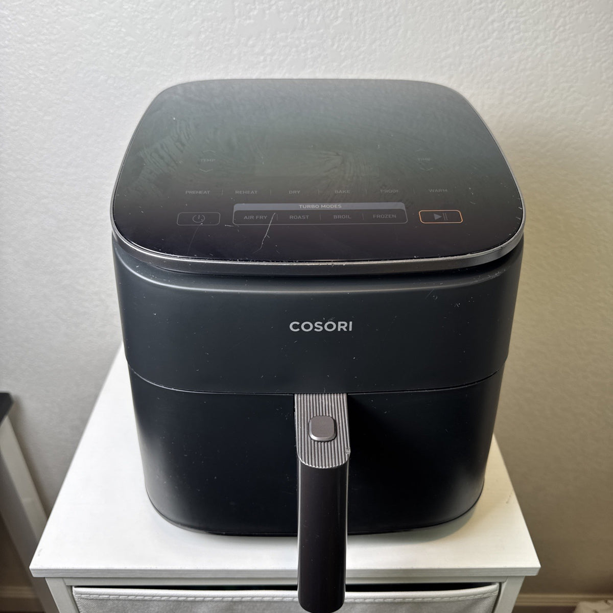 Black Cosori TurboBlaze 6-quart air fryer showing top control panel and front basket