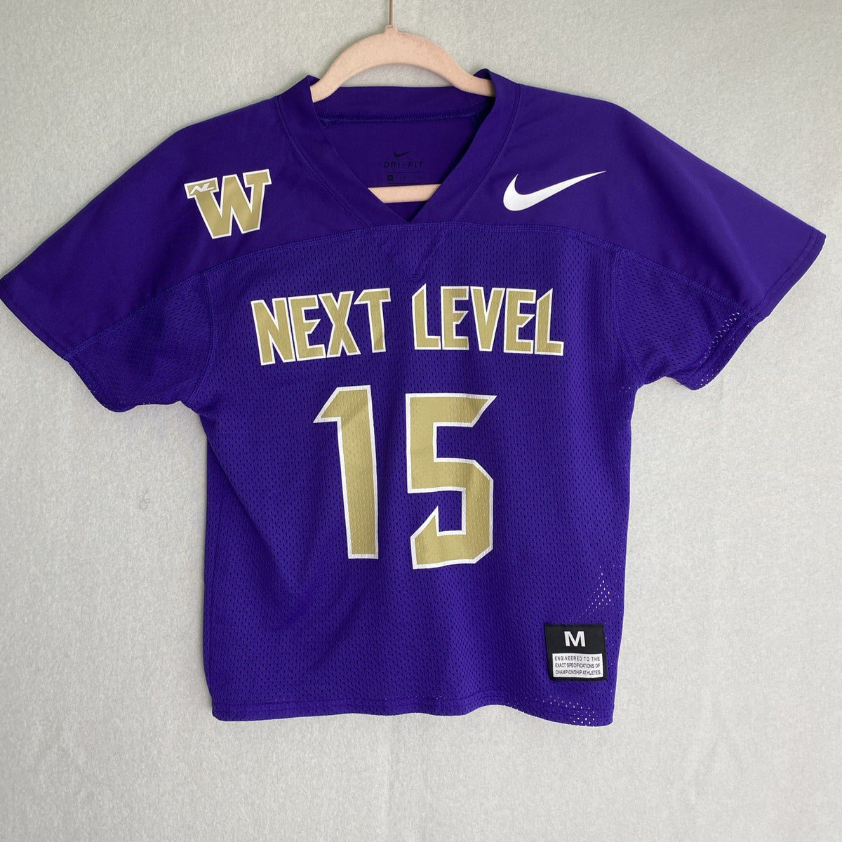 Front and back of purple Nike Dri-FIT Washington Huskies mesh jersey shirt in women's size medium with Keates 15 graphics.