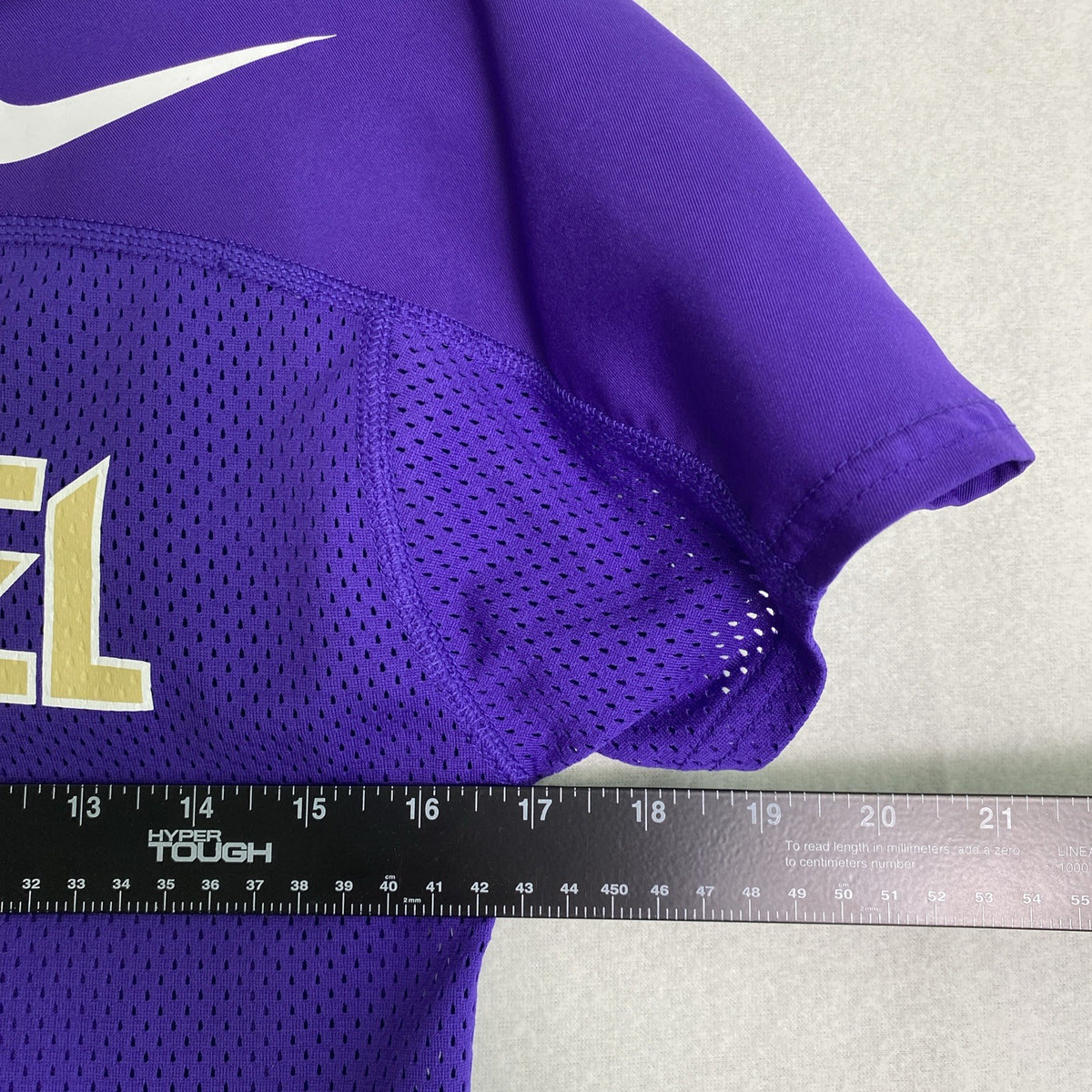 Front and back of purple Nike Dri-FIT Washington Huskies mesh jersey shirt in women's size medium with Keates 15 graphics.