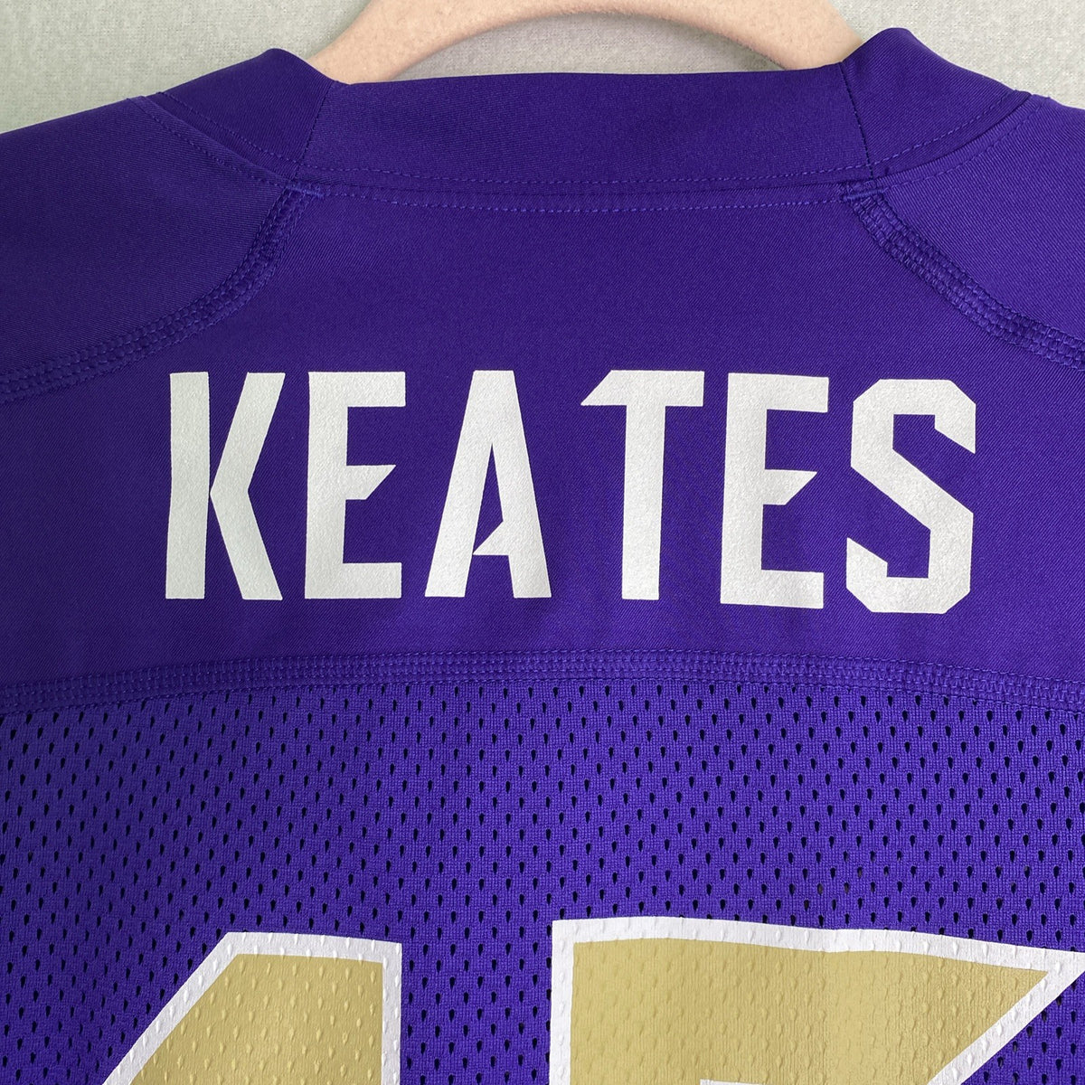 Front and back of purple Nike Dri-FIT Washington Huskies mesh jersey shirt in women's size medium with Keates 15 graphics.
